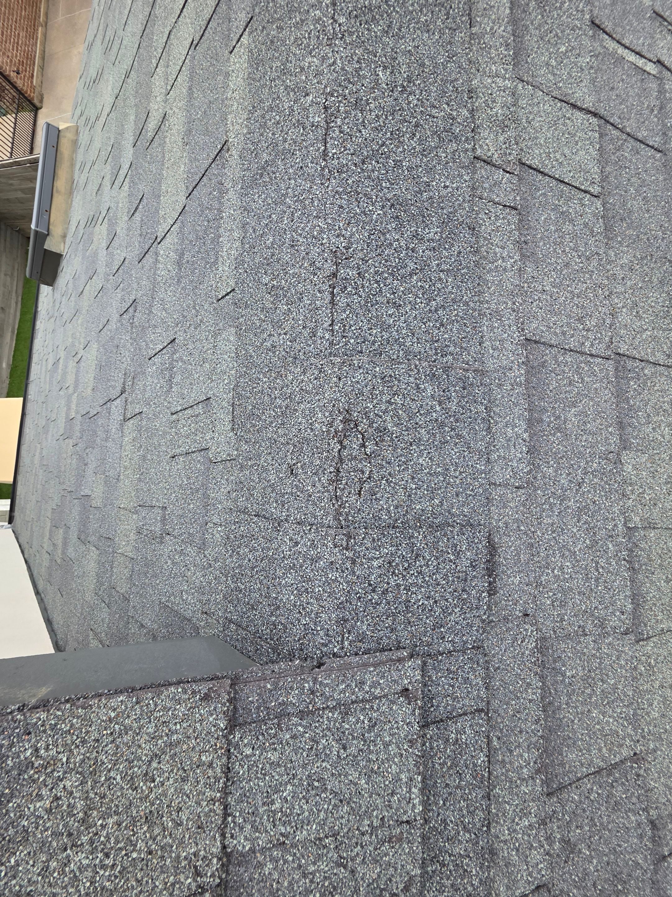 Ridge shingle tear damage on DFW roof requiring insurance claim